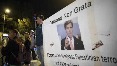 Israeli protesters hold banners when U.S. Secretary of State John Kerry was in Jerusalem for peace talks March 31, 2014. Credit: Yonatan Sindel/Flash90.