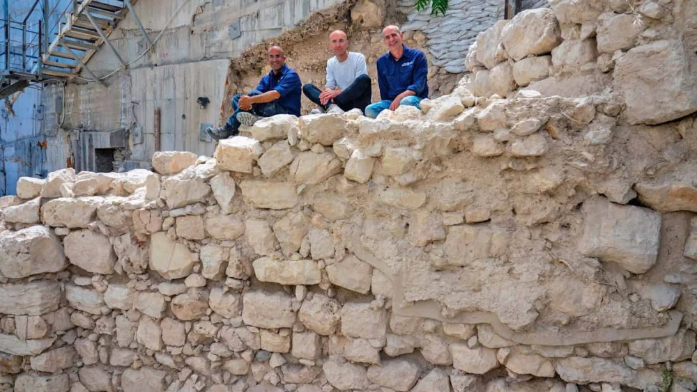 The wall of Jerusalem as uncovered in the excavations of the Israel Antiquities Authority, with, from left, Ortal Chalaf, Dr. Filip Vukosavovich and Dr. Joe Uziel. Photo by Kobi Harati/City of David Foundation.