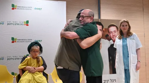 Shalom Yaniv (left), father of terror victims Hallel and Yagel Yaniv, hugs Ron Carmeli, who received a donated cornea, at Beilinson Hospital in Petach Tikvah, June 18, 2023. Photo by Yossi Zeliger/TPS.