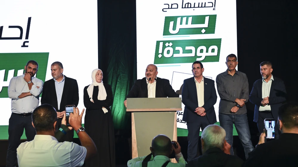 United Arab List (Ra’am) party chairman Mansour Abbas stands alongside fellow party members on stage following the release of exit poll results in the northern Israeli city of Sakhnin, on Israel’s general election night, Oct. 27, 2026. Photo by Michael Giladi/Flash90.