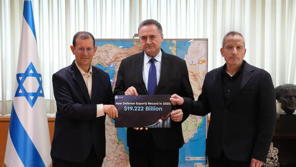 Officials from the Israeli Defense Ministry hold a sign marking a new record of $19.2 billion in defense exports for 2025, as they present the annual report at ministry headquarters on June 2, 2026. Photo by Ariel Hermoni, Israel Ministry of Defense.