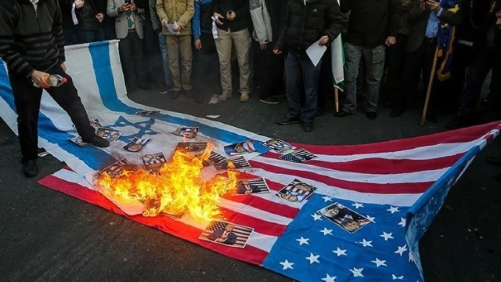 American and Israeli flags being burned after the relocation of the U.S. embassy from Tel Aviv to Jerusalem was announced. Credit: Tasnim News Agency.
