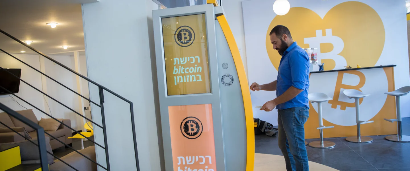 On Nov. 5, 2018, a man uses a bitcoin ATM machine at the Bitcoin Change center on Dizengoff Street in Tel Aviv. The center houses the ATM, as well as a museum on the history of the cryptocurrency. Credit: Miriam Alster/Flash90.