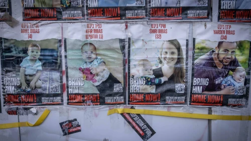 Pictures of the Bibas family hang on a wall outside the Knesset, the Israeli parliament in Jerusalem, Feb. 19, 2024. Photo by Chaim Goldberg/Flash90.