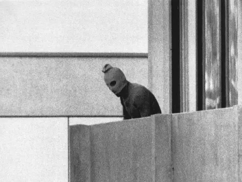 A terrorist appears with a hood over his face on the balcony of the building where members of the Olympics Israeli team were held hostage in Munich, Sept. 5, 1972. Photo credit: AP Photo/Russell McPhedran/Wikimedia Commons