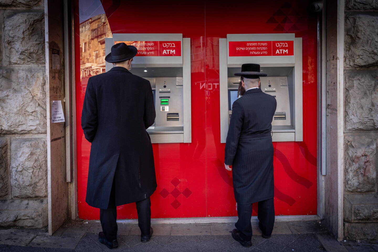 Men at ATM machines in the haredi neighborhood of Mea Shearim in Jerusalem, Feb. 5, 2024. Photo by Chaim Goldberg/Flash90.