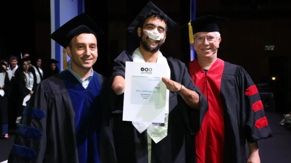 Alon Kaminer (middle) with his faculty during his graduation ceremony at the Tel Aviv University, on June 10, 2026. Credit: Tel Aviv University.