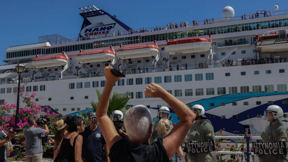 Greek riot police stand guard as pro-Palestinian demonstrators protest against the arrival of the "Crown Iris," a cruise liner carrying Israeli tourists, in Agios Nikolaos, Crete, July 29, 2025. Photo by Costas Metaxakis/AFP via Getty Images.