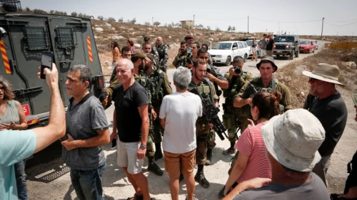 Israeli soldiers detain Israeli left-wing activists during a tour conducted by NGO Breaking the Silence in Mitzpe Yair, near Hebron in Judea and Samaria, on Aug. 31, 2018. Photo by Wisam Hashlamoun/Flash90.