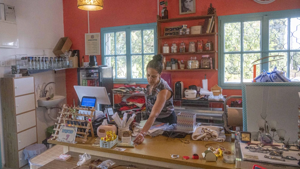 Lilach Agra works at her thrift shop in Kibbutz Eilon on June 24. 2025. Photo by Canaan Lidor.