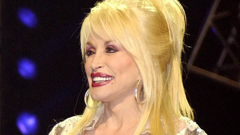 Music legend Dolly Parton on stage at the Grand Ole Opry during a live broadcast in Nashville, Tenn., on April 23, 2005. Credit: U.S. Department of Defense photo by Tech. Sgt. Cherie A. Thurlby, U.S. Air Force/Public Domain via Wikimedia Commons.