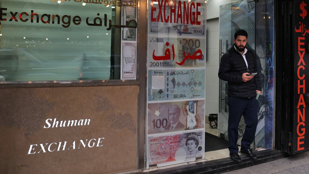 A man stands at the entrance of a currency exchange office in Beirut on March 14, 2023. Photo by Anwar Amro/AFP via Getty Images.