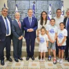 President Isaac Herzog, Aliyah and Integration Minister Ofir Sofer, and Nefesh B'Nefesh founders Rabbi Yehoshua Fass and Tony Gelbart welcome Atara and Jeffrey Douglas (in white shirts) and their children, Emilia, 6, Nathaniel, 10, and Hallie, 9, at the President’s Residence in Jerusalem on Aug. 9, 2026. Photo by Yonit Schiller/Nefesh B'Nefesh.