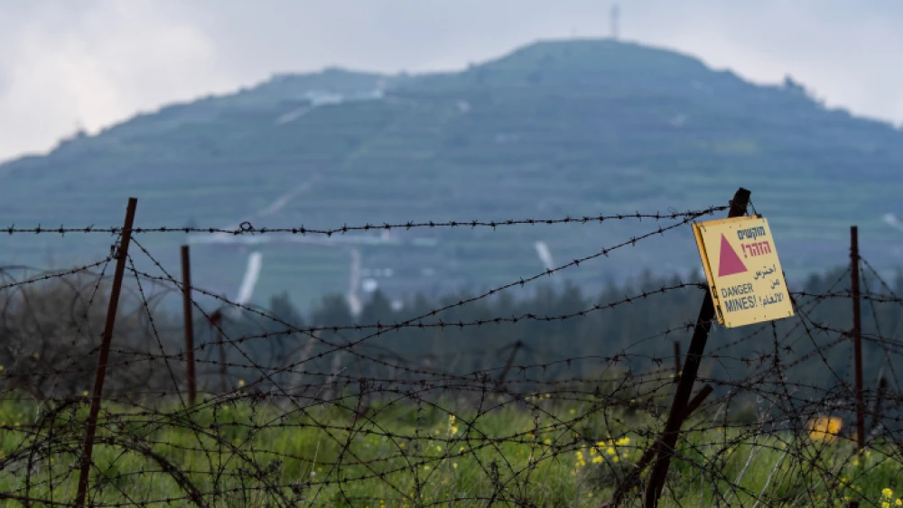 A sign warns of a minefield near the Syrian-Israeli border in the Golan Heights, March 25, 2019. Photo by Basel Awidat/Flash90.