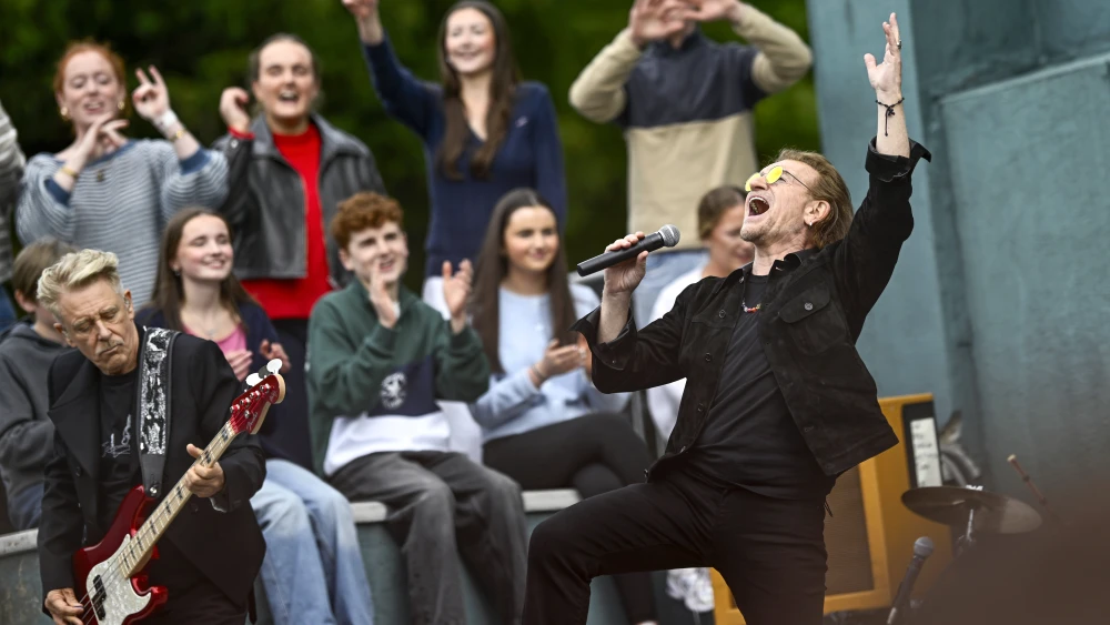Bono, right, performs on stage, as U2 celebrate their 50th Anniversary by returning to Mount Temple Comprehensive School on September 25, 2026 in Dublin, Ireland. Photo by Gareth Cattermole/Getty Images for U2.