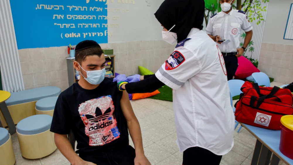 An Israeli student receives a COVID-19 vaccine injection at Amal high school in Beersheva, March 17, 2021. Credit: Flash90.