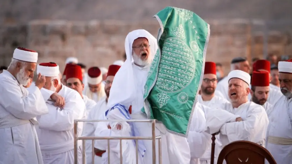 Members of the Samaritan community pray at sunrise during a religious service marking the end of their Passover holiday atop Mount Gerizim, above the West Bank city of Nablus, on May 2, 2021. According to tradition, the Samaritans are descendants of the Jews who were not deported when the Assyrians conquered Israel in 722 B.C. The small community numbers about 810 people, half of them live in a village at Mount Gerizim, near the Palestinian city of Nablus, and the rest in Holon near Tel Aviv in Israel. Photo by Nasser Ishtayeh/Flash90.