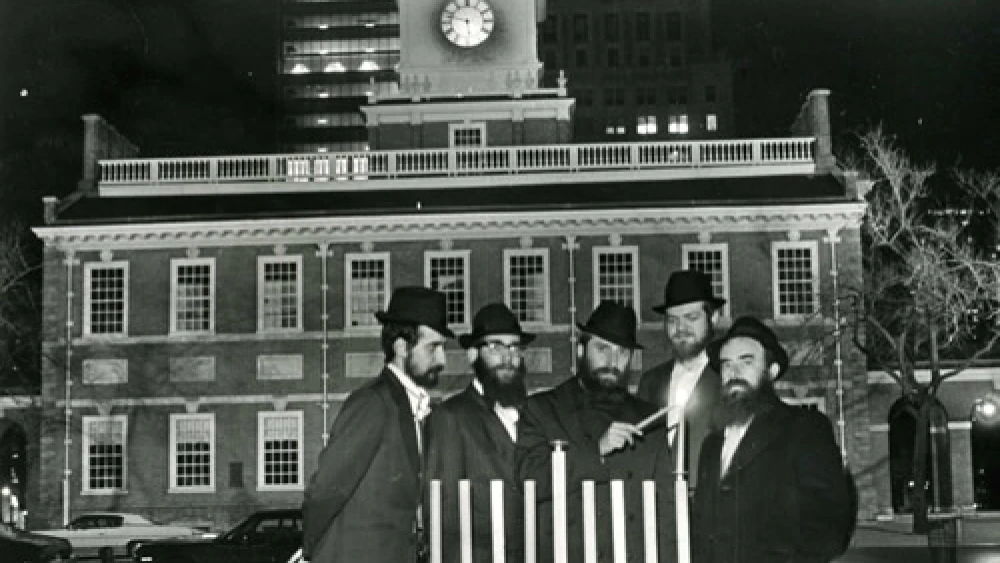 Rabbi Abraham Shemtov, right, in front of Independence Hall in Philadelphia at the lighting of the first-ever public menorah in 1974. With him were yeshivah students who helped build the menorah from scratch. Credit: Lubavitcher Center/Chabad.org.