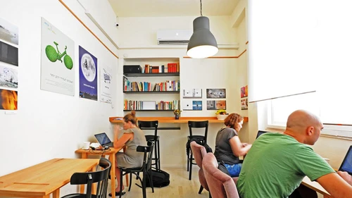 "Misanthrope," a shared workspace in Tel Aviv that is a haven for Israeli writers. In return for a small hourly fee, Misanthrope customers enjoy unlimited free coffee, fresh fruit, WiFi, and a comfortable public quiet space to work on personal projects. Credit: Courtesy.