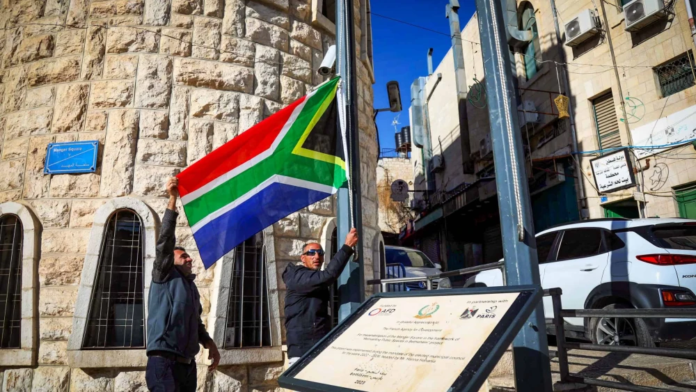 Bethlehem municipality employees raise a South African flag as a sign of support for the country's suit against Israel to the International Court of Justice, Bethlehem, Jan. 16, 2024. Credit: Wisam Hashlamoun/Flash90.