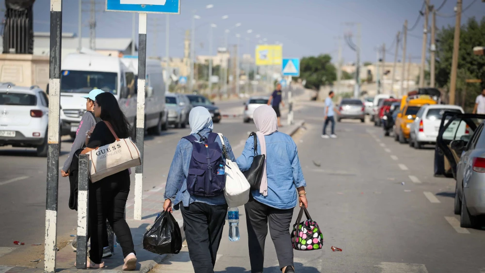 Palestinians who flee from their homes wait at the Rafah border crossing to Egypt in the southern Gaza Strip, on Oct. 14, 2023. Photo by Atia Mohammed/Flash90.