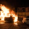 A car is set on fire during clashes between Arab and Jews in Acre, northern Israel, May 12, 2021. Credit: Roni Ofer/Flash90