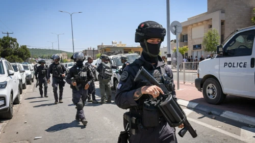 Police stand guard during a protest against the construction of a wind farm near Majdal Shams in the Golan Heights, June 21, 2023. Photo by Ayal Margolin/Flash90.