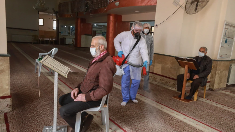 Palestinian workers disinfect a mosque in Ramallah as a preventive measure against the coronavirus on March 7, 2020. Photo by Flash90.