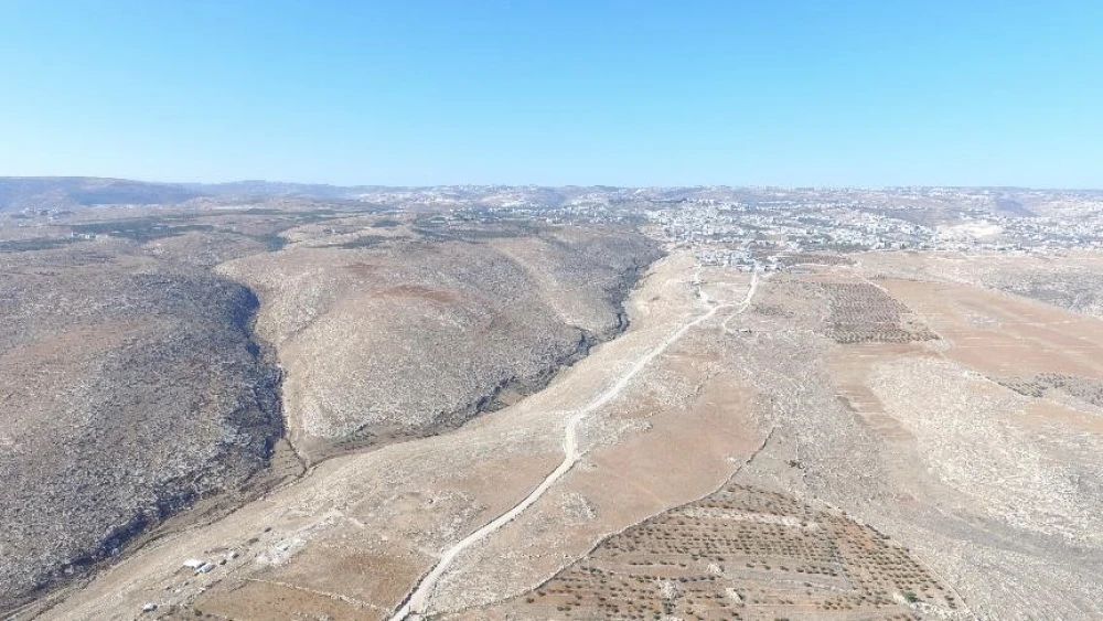 On Dec. 7, 2015, a representative of Regavim documented the completion of the preparations for paving. The images captured by drone photography clearly show that only a small section of the road passes through agricultural areas, while the vast majority of the road lies in arid, uninhabited areas, thus making it clear that the object of the Arab-oriented project is to seize territory in Area C and to annex the lands needed for a contiguous Palestinian state. Credit: Regavim.