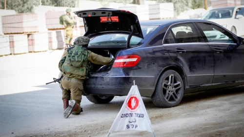 An Israeli soldier searches a vehicle in Hebron on Nov. 4, 2016. Photo by Wisam Hashlamoun/Flash90.