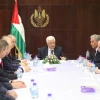 Palestinian Authority leader Mahmoud Abbas (center) meets with the new Fatah-Hamas unity government in the West Bank city of Ramallah on June 2, 2014. Credit: Issam Rimawi/Flash90.