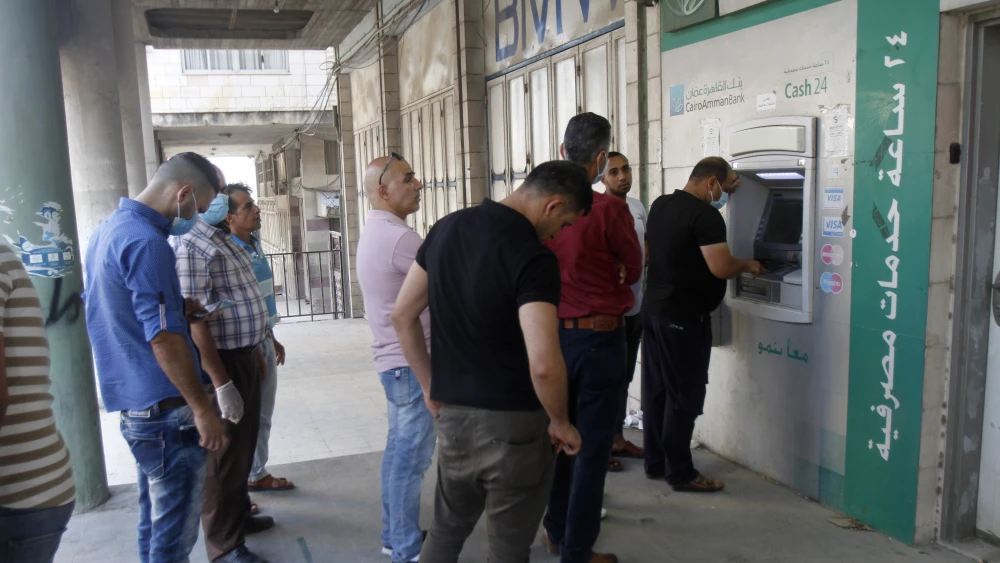 Palestinians queue to an ATM in the Samaria city of Nablus (Shechem), July 2, 2020. Photo by Nasser Ishtayeh/Flash90.