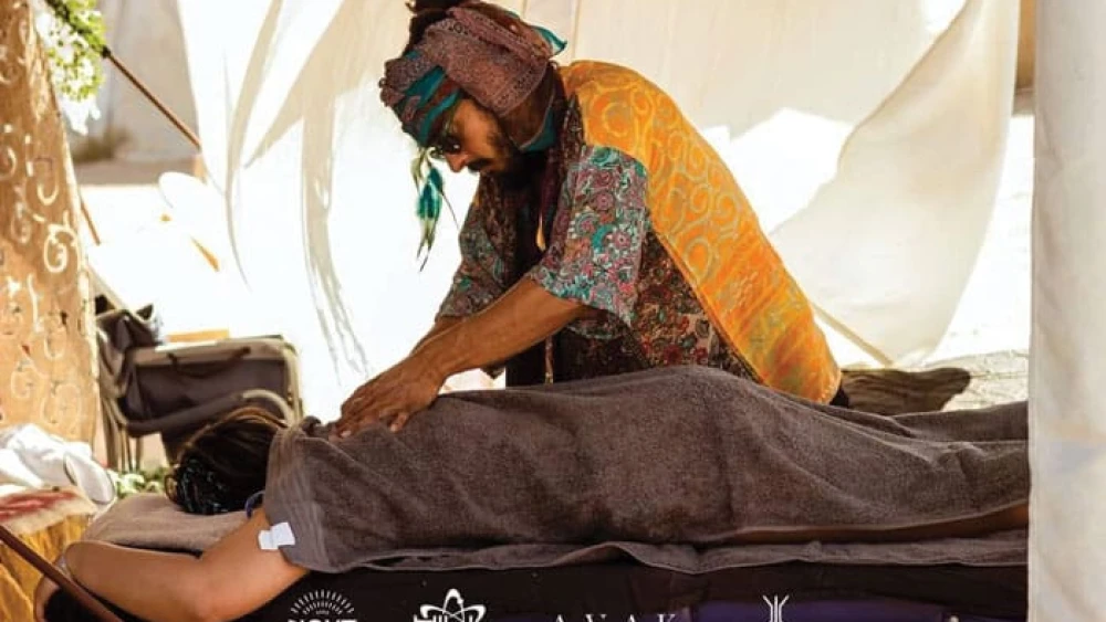 Dor Kapah gives a massage to a music festival participant. Photo by Inor Kagno.