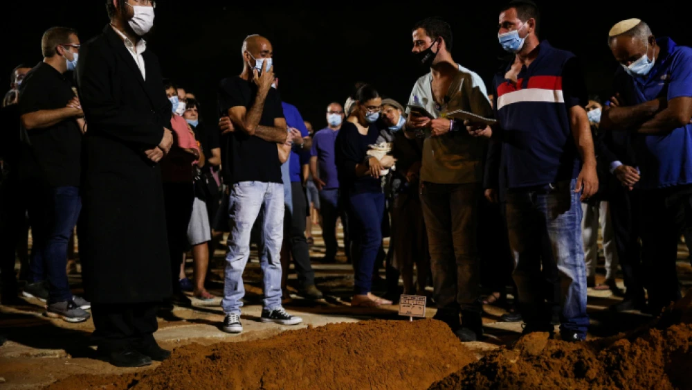 Family and friends attend the funeral of Rabbi Shai Ohayon at the Segula cemetery in Petach Tikvah on Aug. 27, 2020. Ohayon was stabbed to death just hours earlier in an apparent terrorist attack. Photo by Noam Revkin Fenton/Flash90.