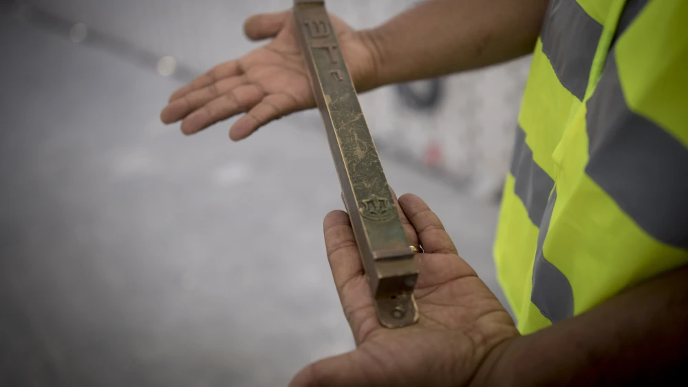 A man holds a “mezuzah” at the site of the new National Memorial Hall at the entrance to the military cemetery on Mount Herzl in Jerusalem on April 27, 2017. Photo by Yonatan Sindel/Flash90.