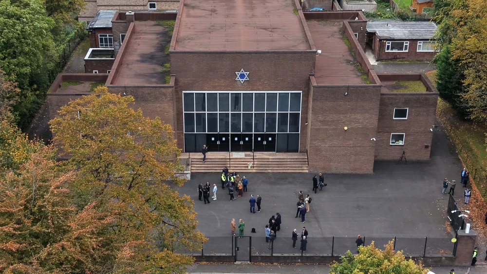 Members of the community gather after a vigil t Heaton Park Hebrew Synagogue on October 09, 2025 in Manchester, England, the U.K. Photo by Christopher Furlong/Getty Images.