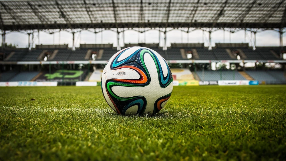 A soccer ball on a field. Credit: jarmoluk/Pixabay.
