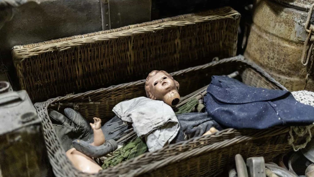A doll's head lies inside one of the boxes storing a cache of items from the Auschwitz former death camp in Poland, donated in January 2025. Photo courtesy of Ambassador Yacov Livne/the Foundation of Memory Sites Near Auschwitz-Birkenau.