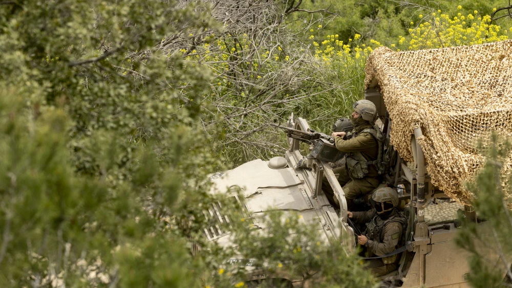 An Israeli soldier sits in an army vehicle as it moves near the border with Lebanon, as seen from a position on the Israeli side of the border on April 15, 2026 in northern Israel. Photo by Amir Levy/Getty Images.