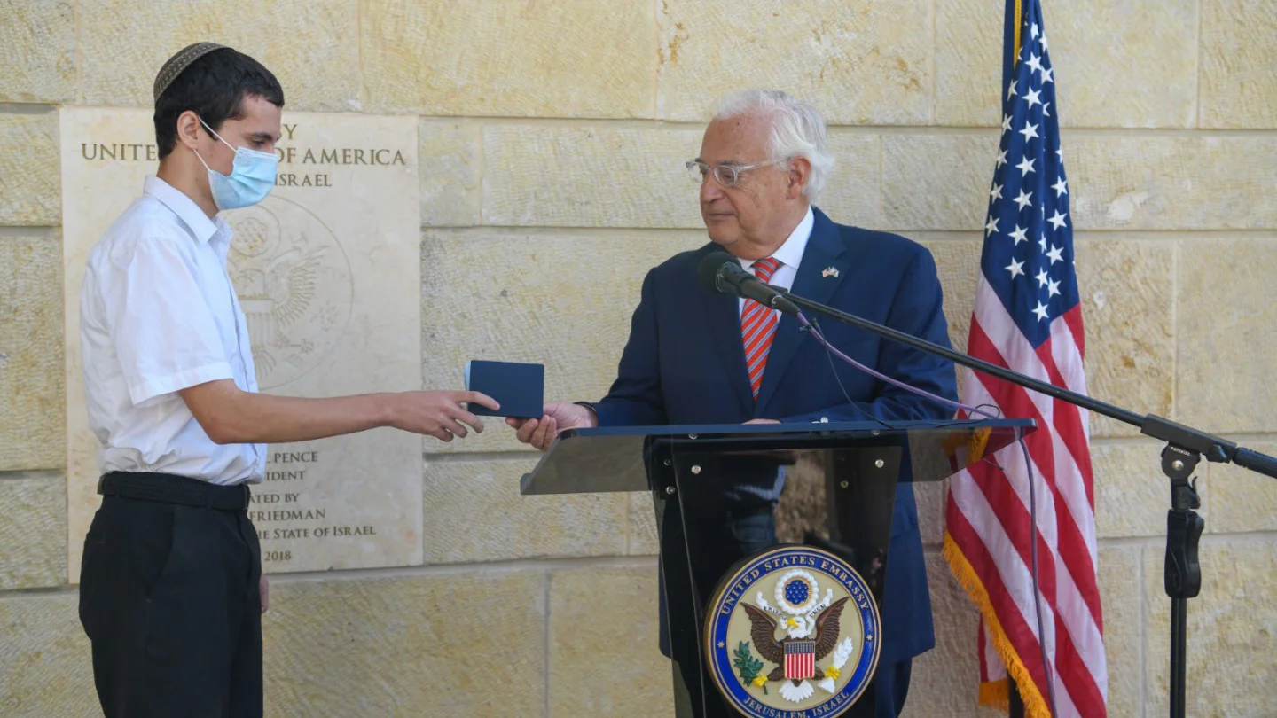 U.S. Ambassador to Israel David Friedman hands the first U.S. passport with “Israel” listed to Jerusalem-born American citizen Menachem Zivotofsky at the U.S. embassy in Jerusalem on Oct. 30, 2020. Source: David M. Friedman/Twitter.