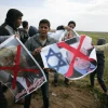 Palestinians demonstrate with posters marring the images of Israeli Prime Minister Benjamin Netanyahu and U.S. President Donald Trump during a protest near Khan Yunis in the southern Gaza Strip on March 30, 2018. Credit: Abed Rahim Khatib/Flash90
