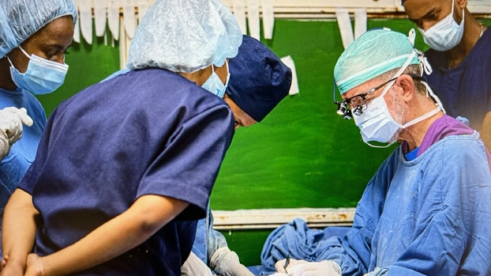 Dr. Morris Hartstein performs cataract surgery, observed by local physicians. Photo by Ovi Aviram.