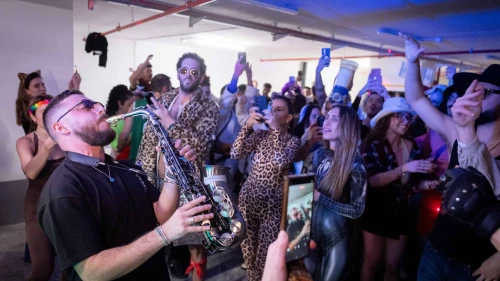 People dance during the Jewish holiday of Purim at an underground parking lot amid missile attacks emanating from the Islamic Republic, March 2, 2026. Photo by Chaim Goldberg/Flash90.