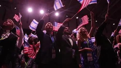 Attendees of the 10th Christians United for Israel (CUFI) Washington Summit wave Israeli and American flags, July 13, 2016. Credit: CUFI via Facebook.