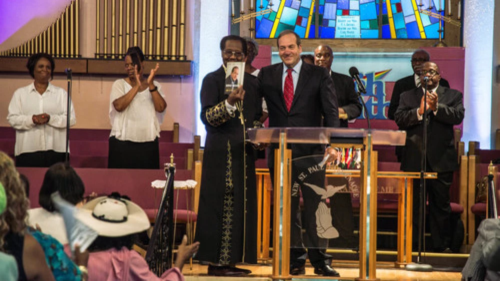 In August 2015 in Detroit, Rabbi Yechiel Eckstein (center right, at podium), founder and president of the International Fellowship of Christians and Jews, visits the New St. Paul Tabernacle Church of God in Christ, which is part of the nation's largest black Pentecostal denomination. Credit: Justin McMahan.