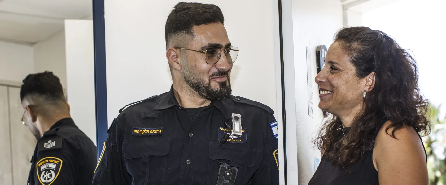 Israel police officer Sgt. 1st Class Hisham Alkarnawi with Aya Meydan, a resident of Kibbutz Be’eri in southern Israel. He helped rescue her on Oct. 7, 2023, during the Hamas-led terrorist attacks, June 15, 2026. Photo by Rina Castelnuovo.