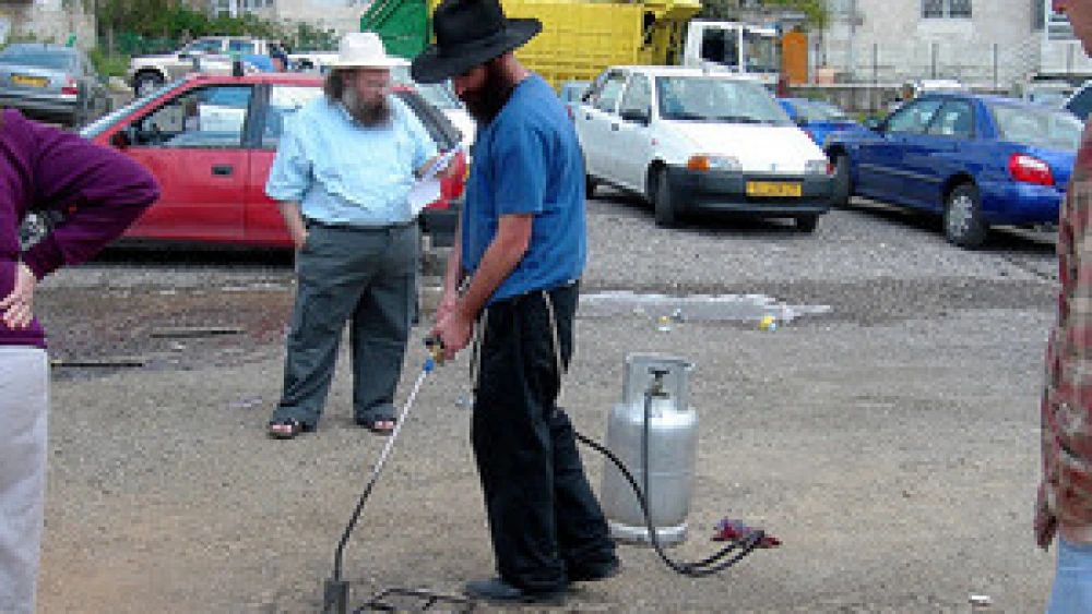 Koshering underway on a Jerusalem street. Credit: Judy Lash Balint.