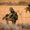 Israeli soldiers take position on a main road near the Israeli-Gaza border, Oct. 10, 2023. Photo by Chaim Goldberg/Flash90.