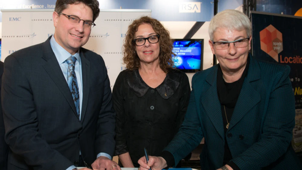 Lockheed Martin and EMC executives sign an agreement to fund collaborative research at the new CyberSpark national cyber-security complex in Beersheva as Ben-Gurion University of the Negev President Professor Rivka Carmi looks on. Credit: Courtesy.