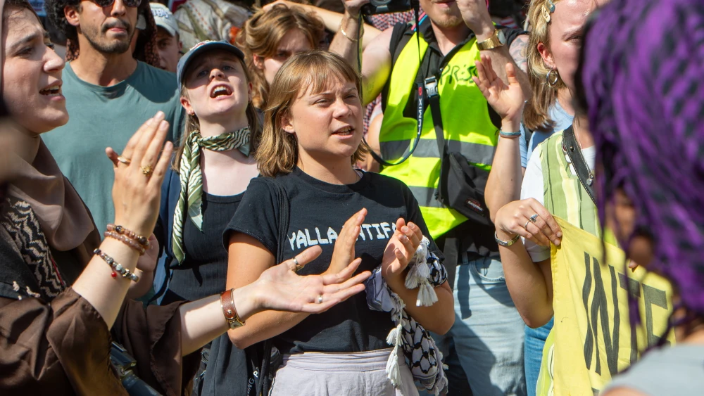 Swedish anti-Israel activist Greta Thunberg wears a "Yalla Intifada" T-shirt as she joins a protest against German defense contractor Rheinmetall's ammunition production facility in Berlin, July 11, 2026. Credit: Craig Stennett/Getty Images.